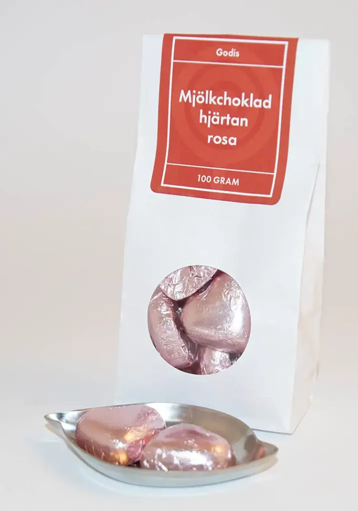 Milk chocolate hearts in pink foil, white bag with a window